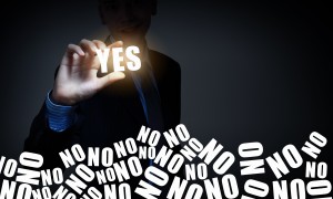 Hand of businessman taking word yes with fingers